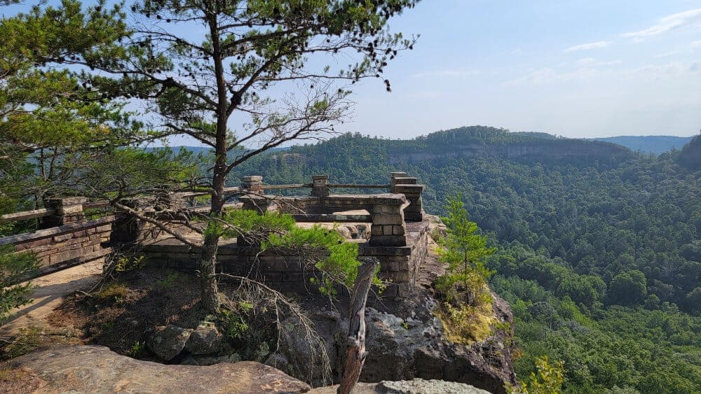 View of the Chimney Top Rock overlook in red River Gorge. Overlook is surrounded by a wooden fence