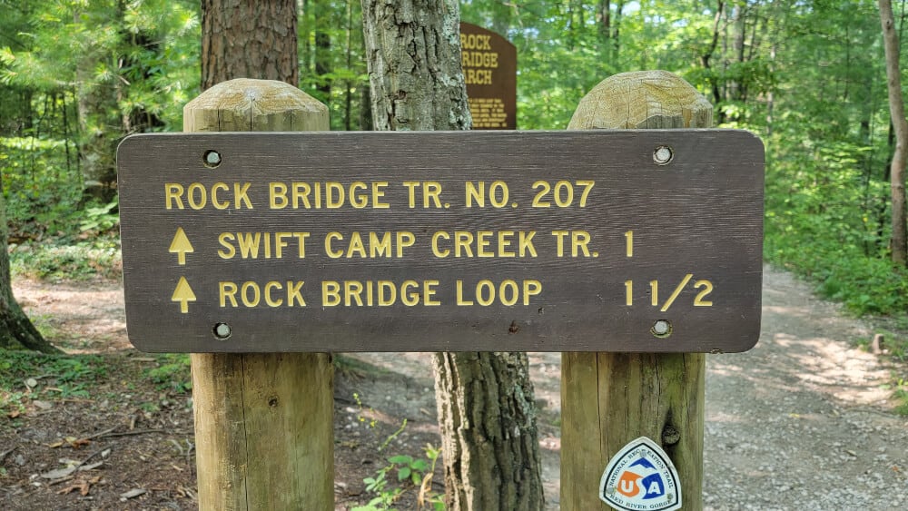 Trailhead sign reads "Rock Bridge Tr No 207" and "swift camp creek tr 1; Rock bridge loop 1 1/2"