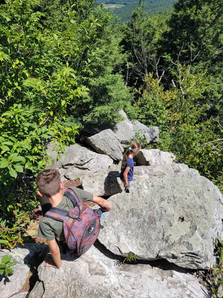 two kids complete a four-point rock scramble down a 30-foot descent at Hawk Mountain