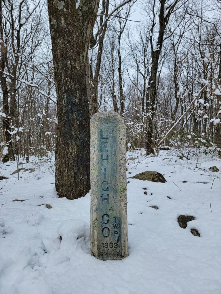 A stone county marker reading "lehigh co" is found along the Appalachian Trail