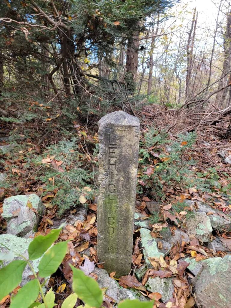 A small stone pillar indicates a new county along the Appalachian Trail. The stone reads "Lehigh Co"