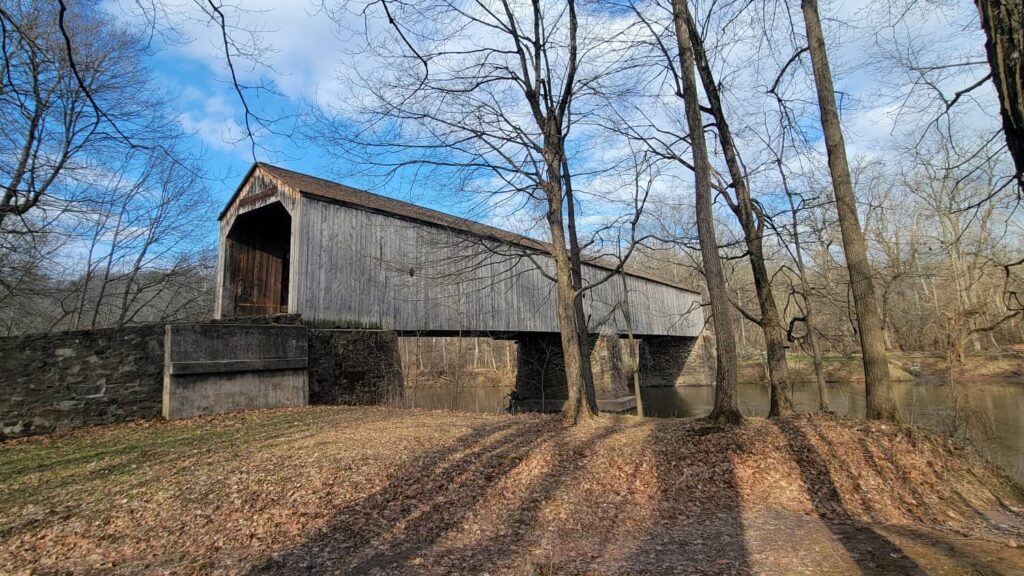 A grey covered bridge seen from the side at Tyler State Park