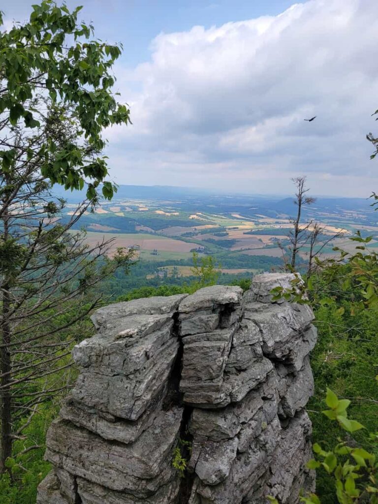 A large rock outcropping is seen with valley in the background from the Pinnacle Overlook
