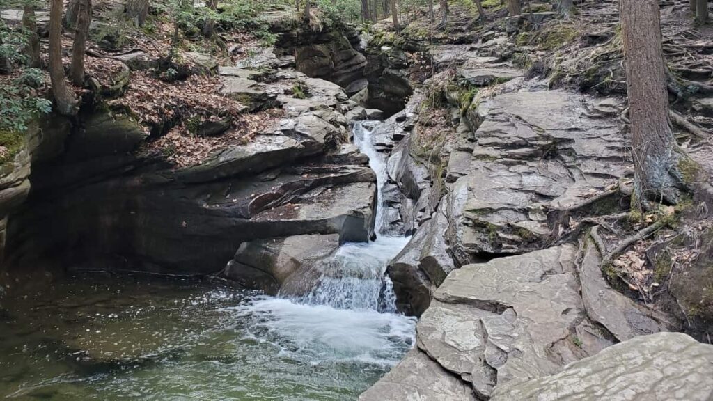 water cascades down rocks in a tub at the seven tubs in Pinchot State Forest in Pennsylvania