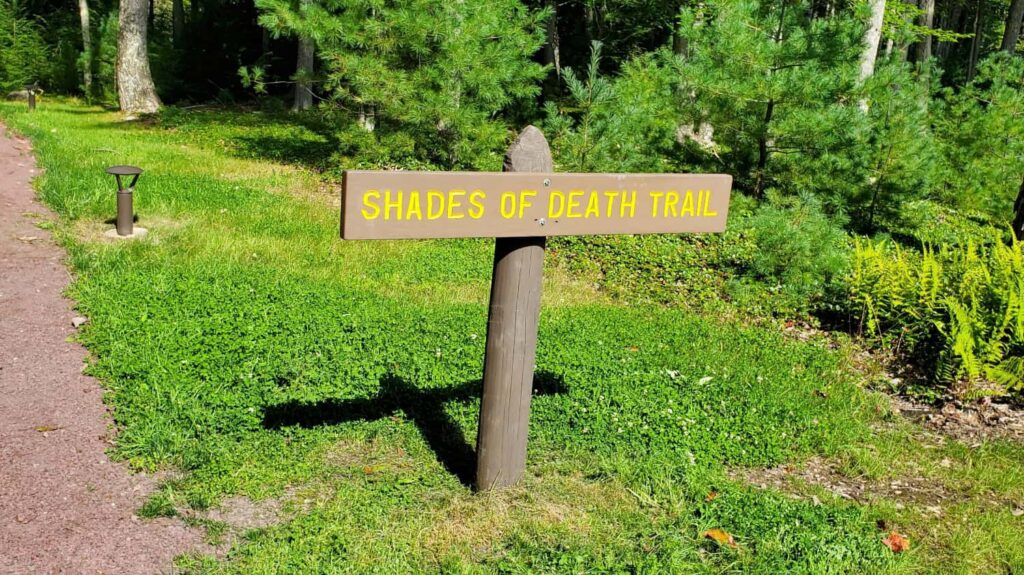 a trailhead signs read "shades of death trail"