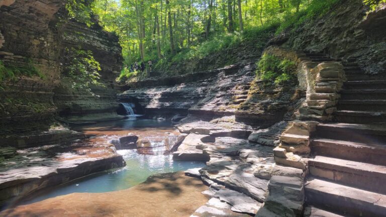 View of small waterfalls and natural pools with stone steps to the right