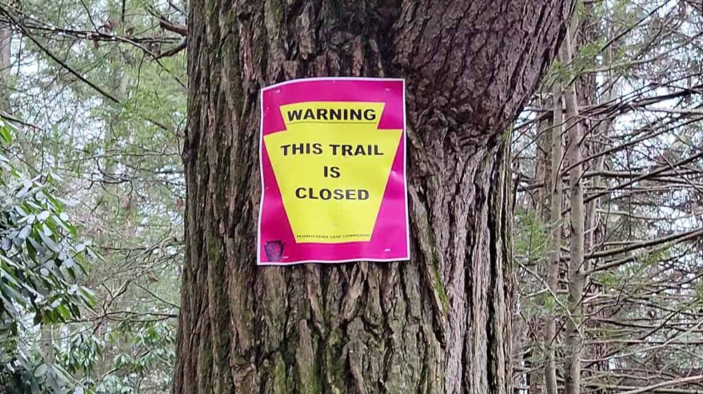 Posted signs states "warning: this trail is closed" along the waterfall trail at Glen Onoko