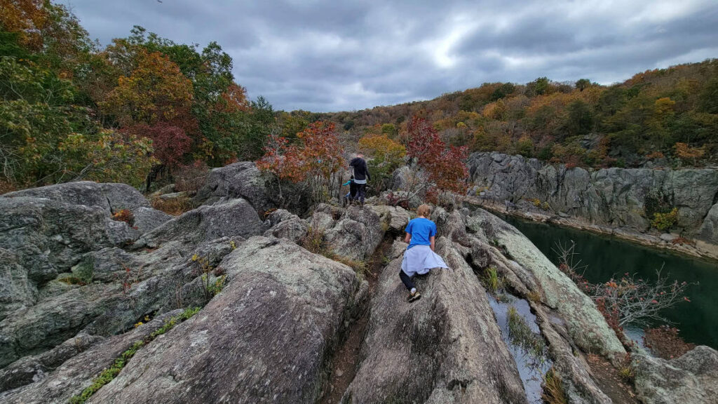 Two kids climb across the rocks along Billy Goat Trail section A