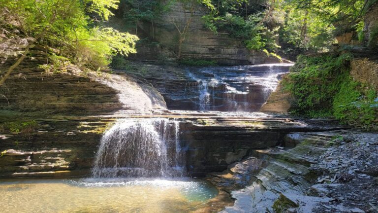 waterfalls spill over rocks along the Buttermilk Falls gorge trail