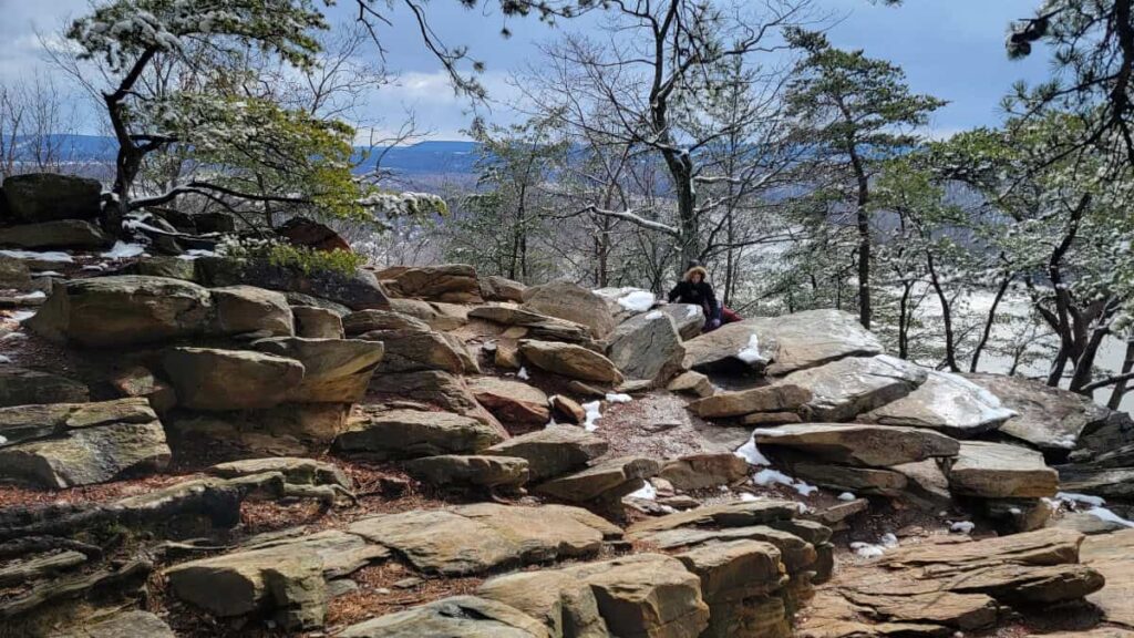 A young girl climbs around on the rocks at Weverton Cliffs