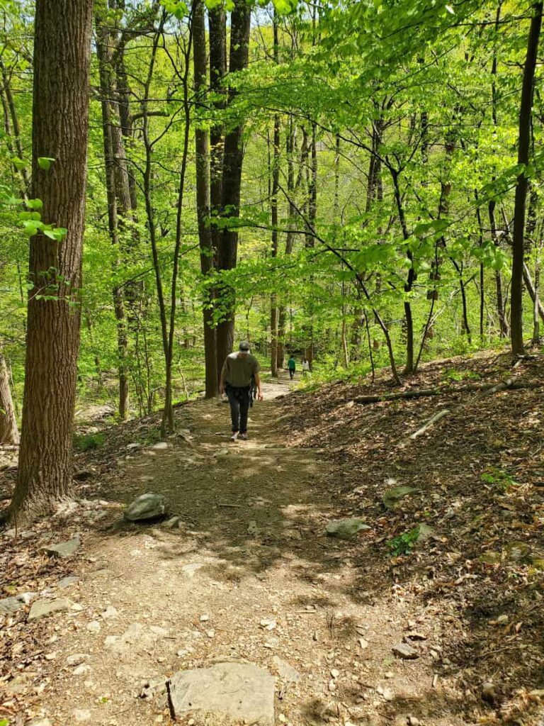 a man hikes up a steep trail in Valley Forge National Historical Park