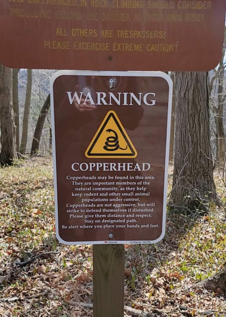 A sign warns visitors about copperhead snakes and how to avoid them