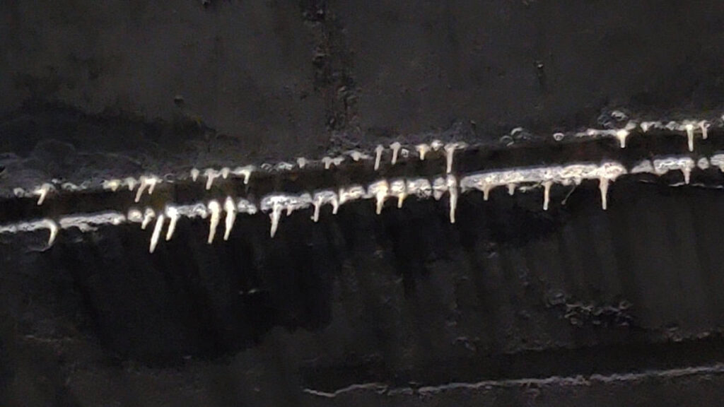 Stalactites grow on the ceiling of an abandoned tunnel