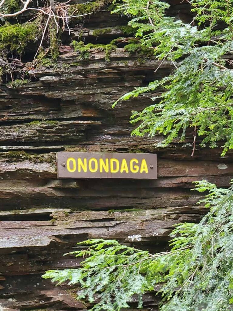 Sign tacked to the stone reads "Onondaga"