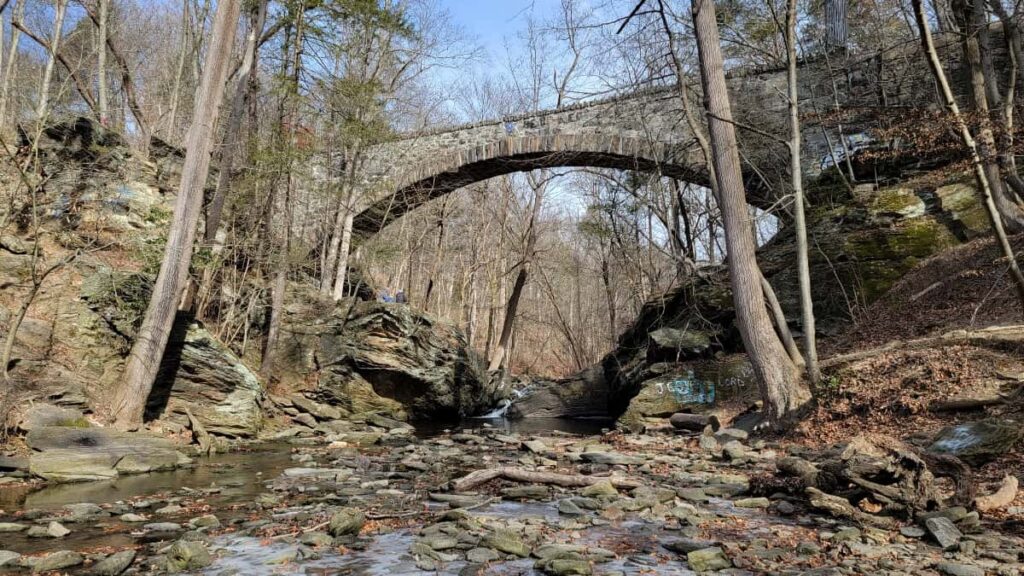 Looking at a stone aqueduct that crosses over the Cresheim Creek in Wissahickon Park