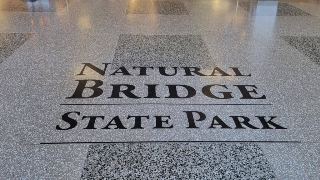 "Natural Bridge State Park" is written on the floor inside the Visitor Center