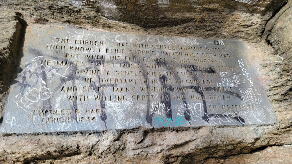 A stone plaque is engraved with a Shakespeare quote