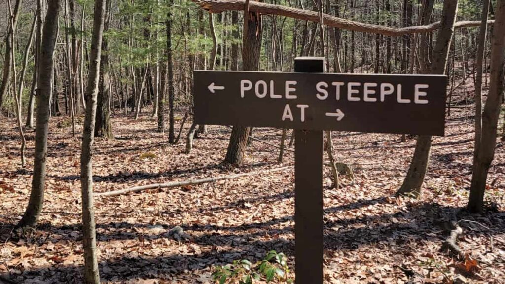 A wooden sign directs hikers to Pole Steeple (left) or Appalachian Trail (right)