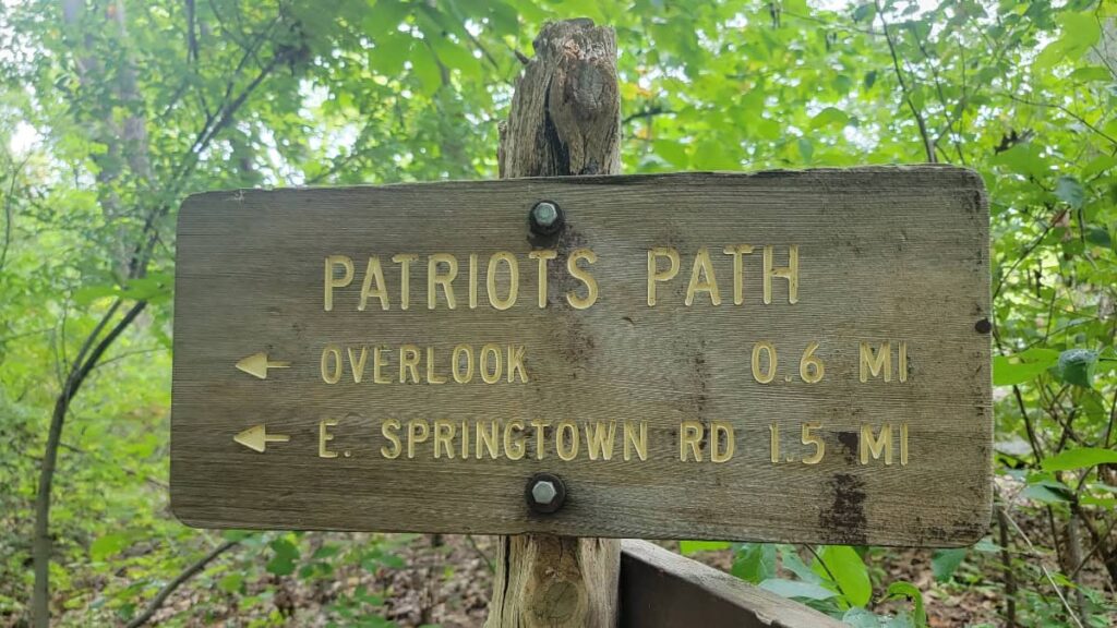 A wooden sign marks the Patriots Path