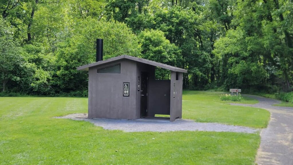 a small bathroom building sits next to the parking lot at Seneca Rocks