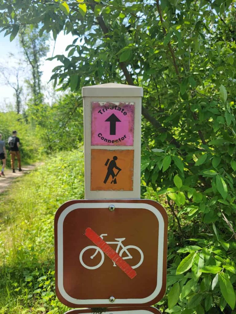 A trail sign post marks the arc connector trail