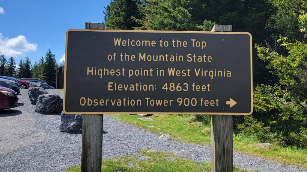 A sign reads Highest Point in West Virginia. Elevation 4863 feet