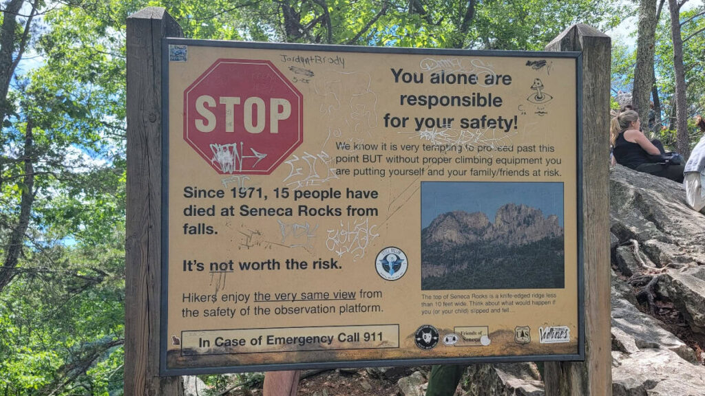 A sign warns hikers not to climb on the rocks at Seneca Rocks
