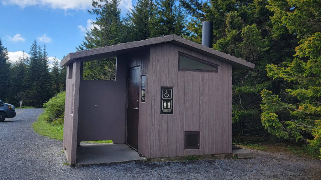 A bathroom building is next to the parking lot at Spruce Knob