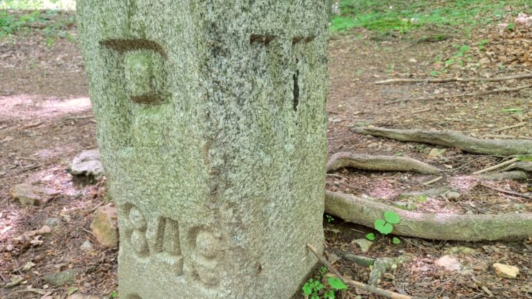 A stone market is engraved with the letter P on one side and M on another