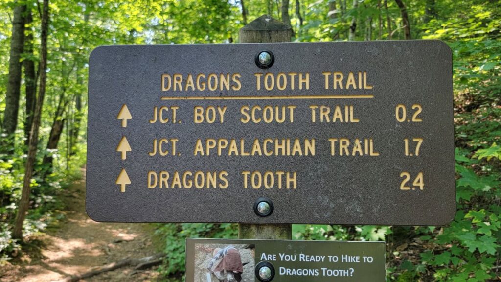Trail sign indicating trail length of boy scout trail and dragon's tooth trail