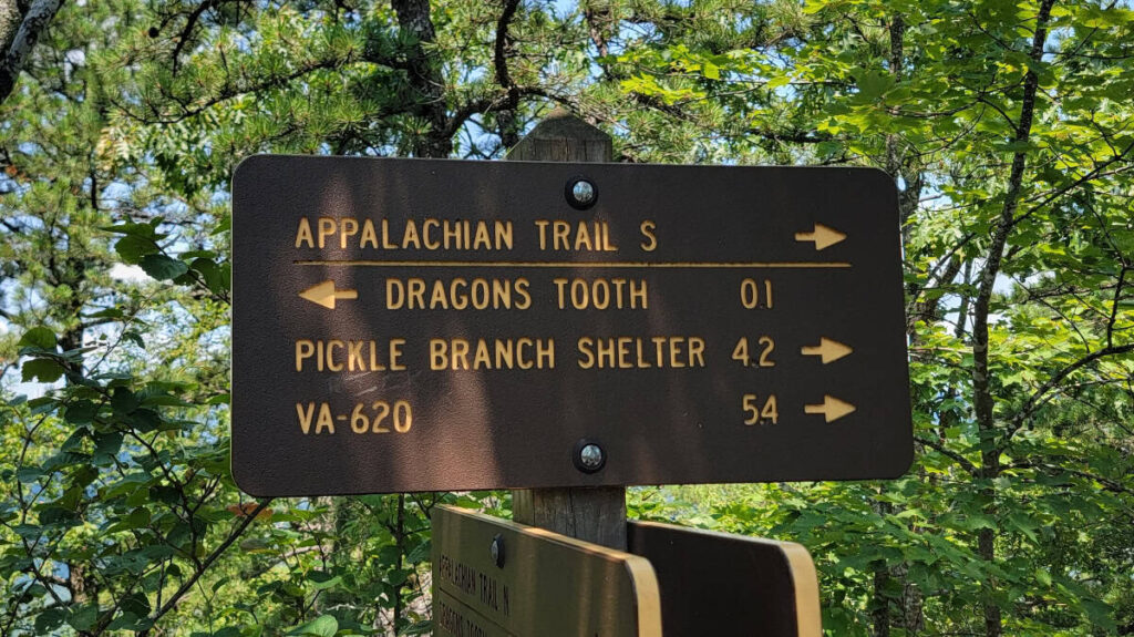 A trail sign directs hikers to the Dragon's Tooth summit