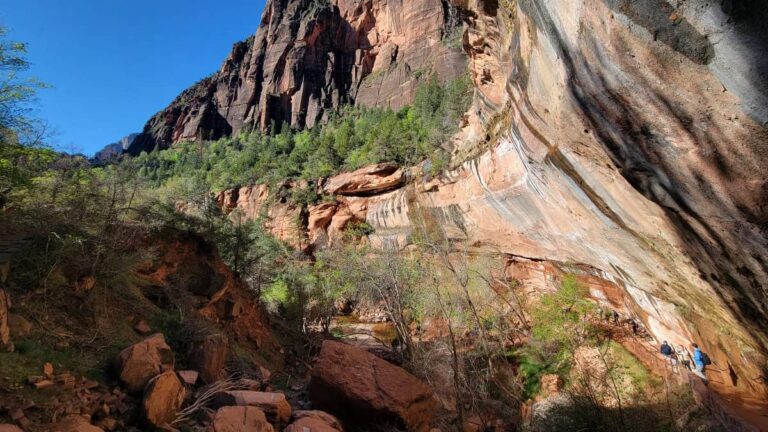 Looking down the Lower Emerald Pools with the canyon orck face curving over the path below