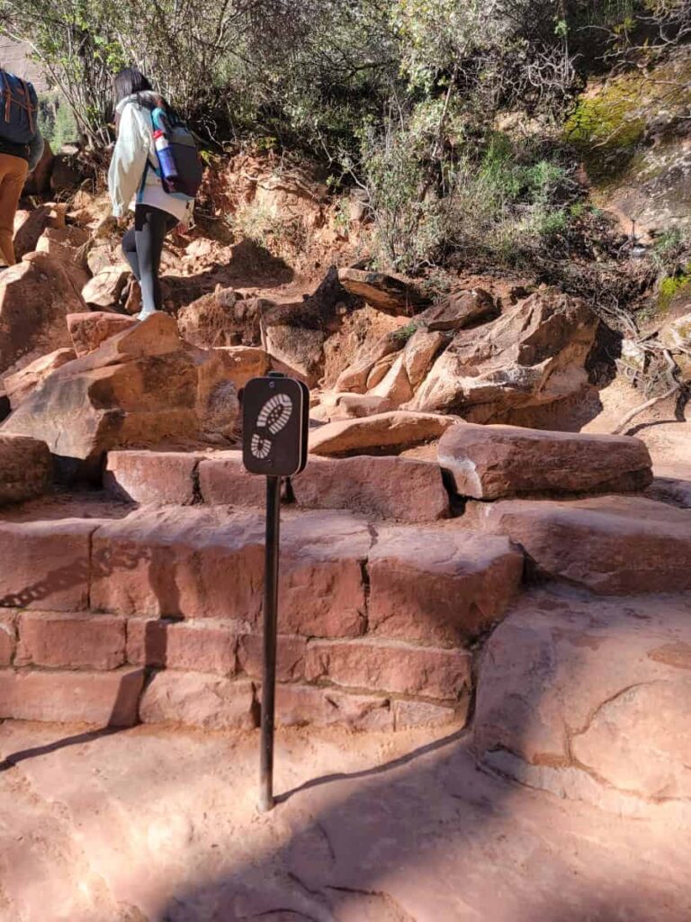 A sign with a hiker's footprint indicates where the trail continues