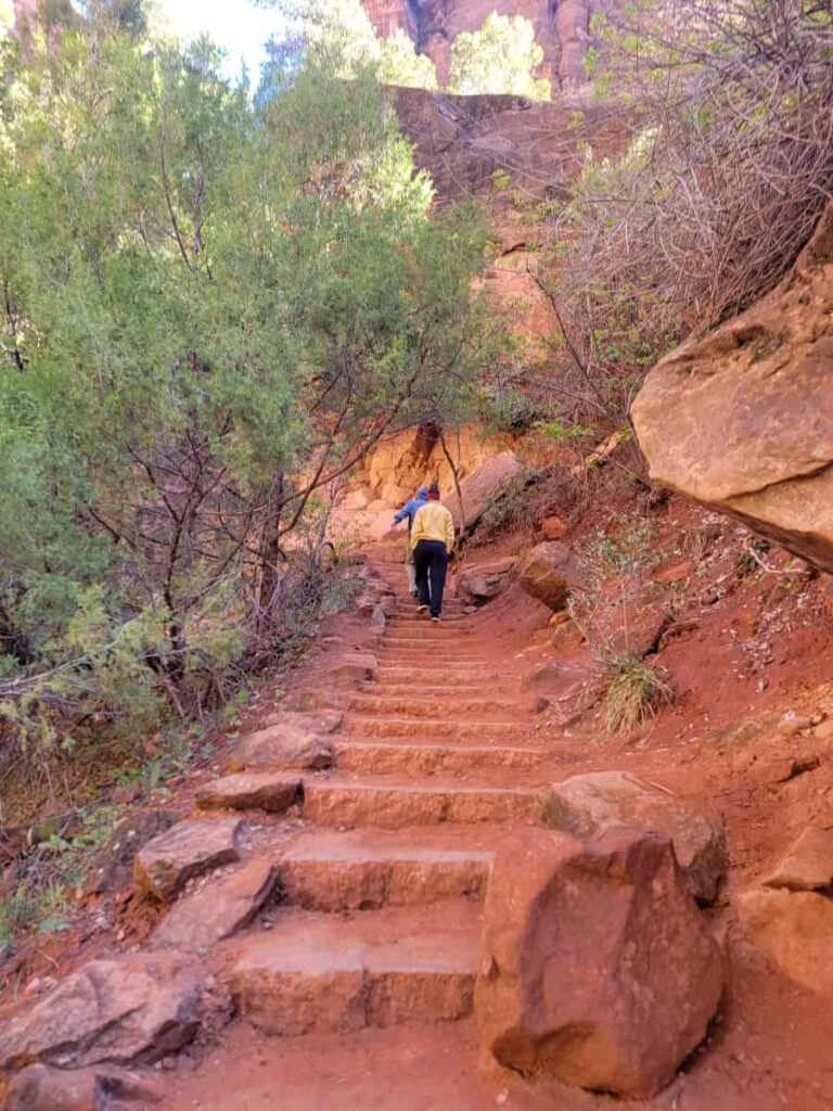 A woman climbs the stone steps to the Middle Pools