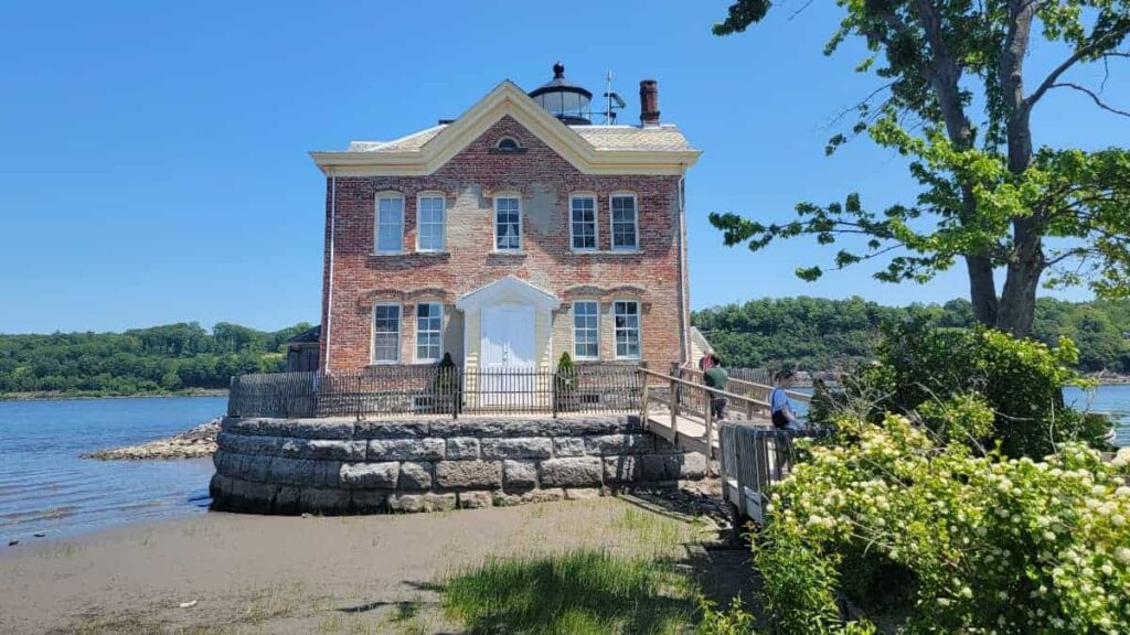 A brick lighthouse sits on the Hudson River in Saugerties New York