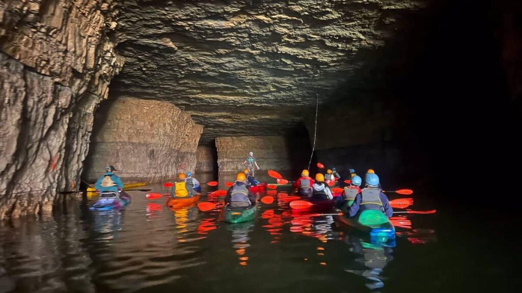 A group of kayakers boat through an abandoned mine in Kentucky