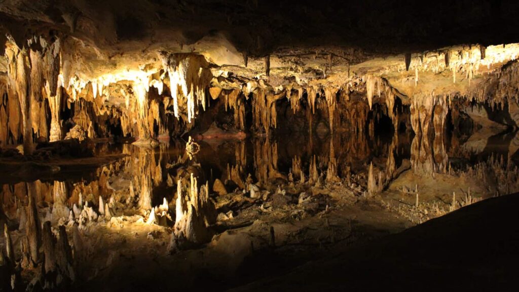 Water reflects the rock formations above inside Luray Caverns