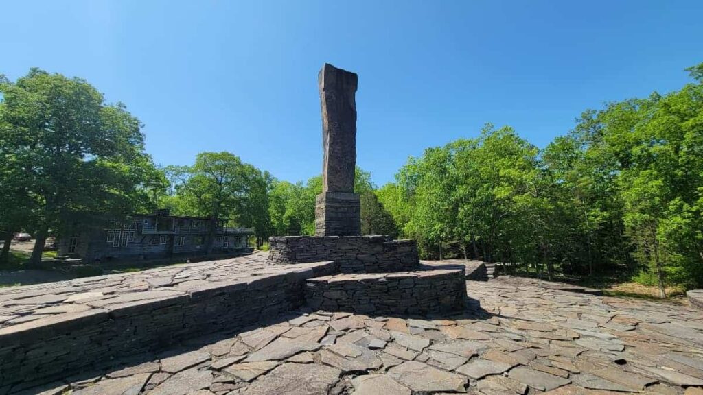 a 13 foot tall stone monolith stands in the center of the large Opus40 sculpture park