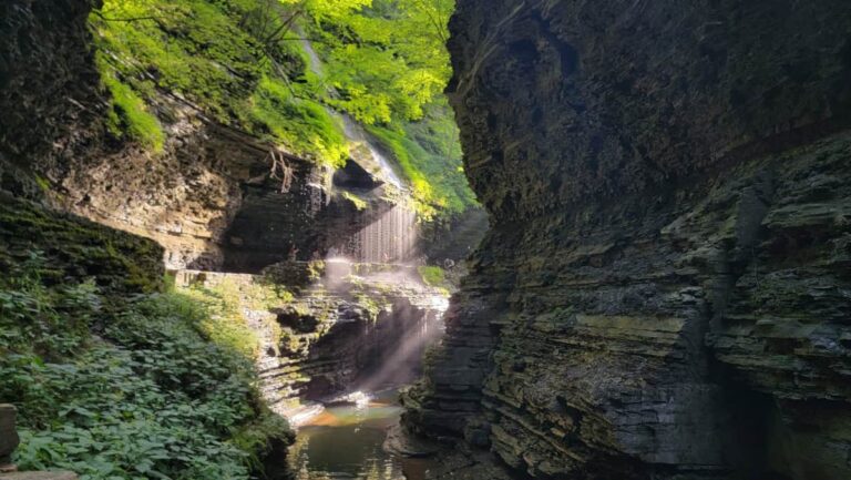 Sun shines on the rocks at Rainbow Falls on Watkins Glen Gorge Trail