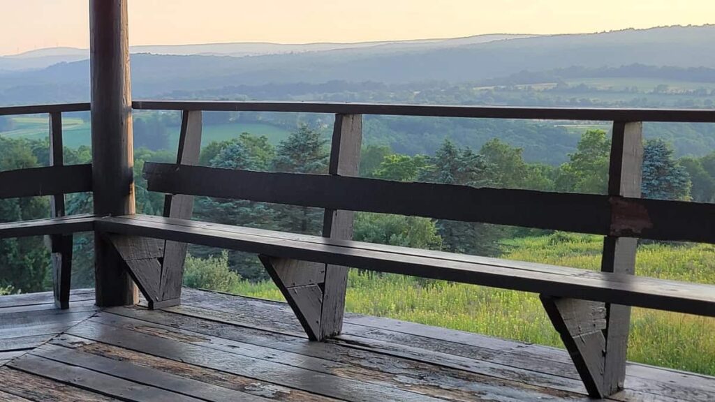 Wood rails and bench seating line the observation tower at Laurel Hill State Park