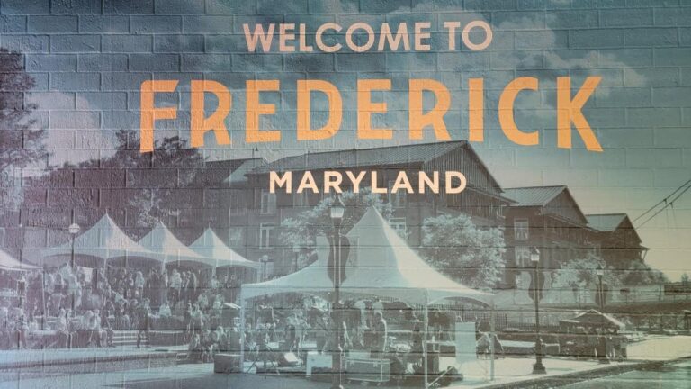 A wall mural says "Welcome to Frederick Maryland"